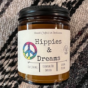 Hippies and Dreams lotion by Teresa Lynns Simple Luxuries.  Presented in 2 sizes of amber glass jars with a white linen label and a tie dyed peace sign on the label.