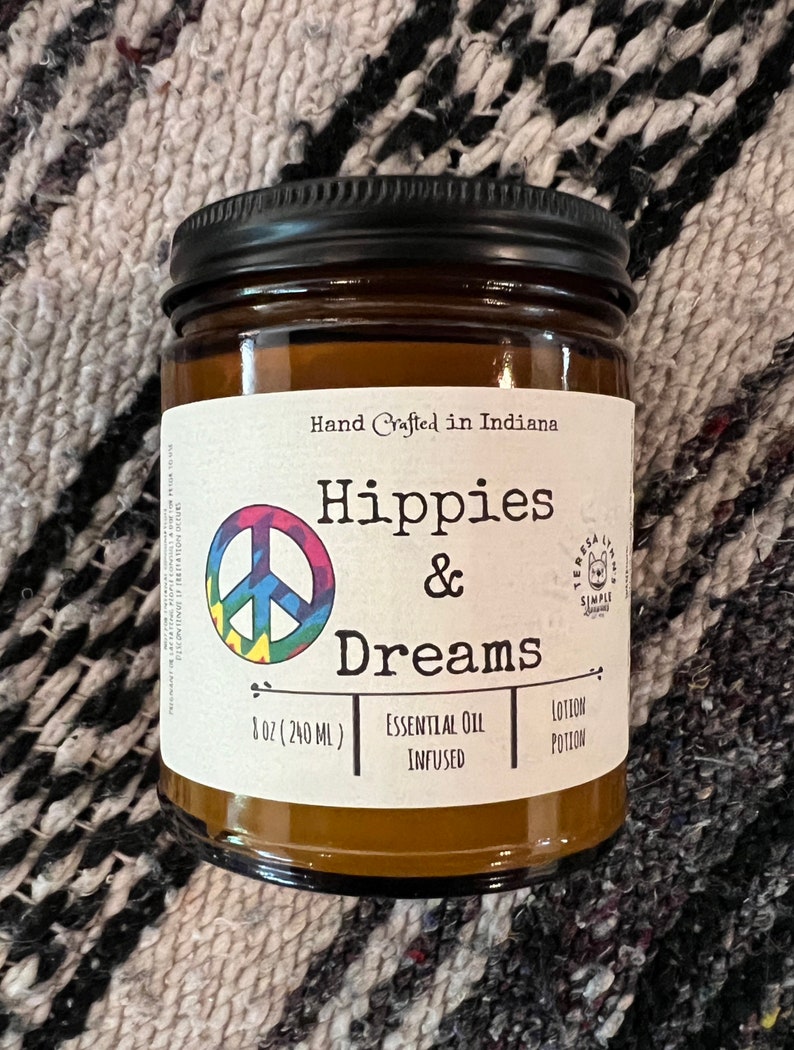 Hippies and Dreams lotion by Teresa Lynns Simple Luxuries.  Presented in 2 sizes of amber glass jars with a white linen label and a tie dyed peace sign on the label.
