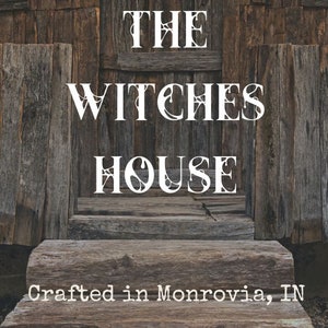 Graphic of the label showing The Witches House in spider web covered font, Crafted in Monrovia, IN.  Potion: Water, Saponified Oils of Sunflower, coconut and olive, goat milk, essential oil, citric acid.The background is a wooden shack with steps.