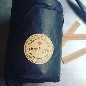 May include: A black paper bag with a brown sticker that says "Handmade with love. thank you. Especially for you." The sticker has a red heart in the center.