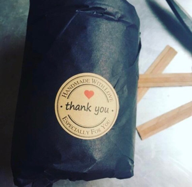 May include: A black paper bag with a brown sticker that says "Handmade with love. thank you. Especially for you." The sticker has a red heart in the center.
