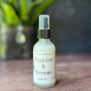 Hippies and Dreams fragrance mist by Teresa Lynns Simple Luxuries.  Presented in an glass spray top bottle with a white linen label and a tie dyed peace sign on the label.