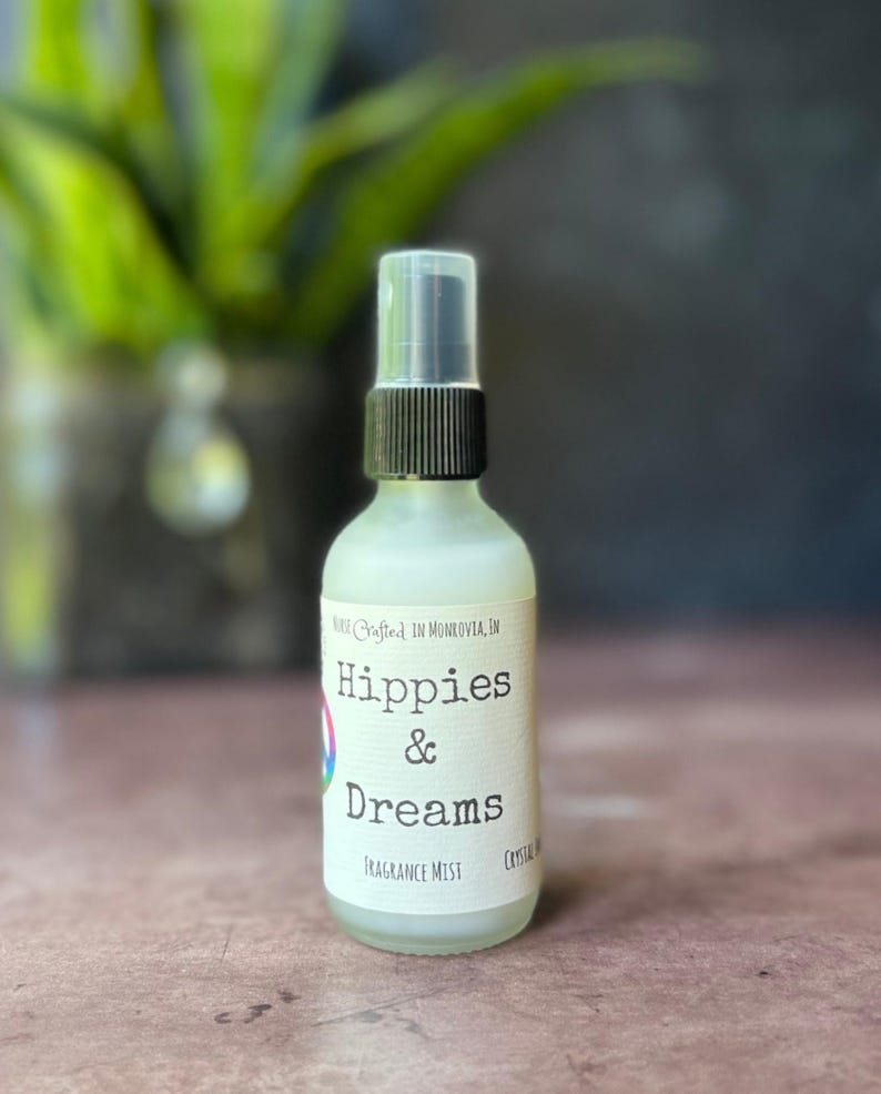 Hippies and Dreams fragrance mist by Teresa Lynns Simple Luxuries.  Presented in an glass spray top bottle with a white linen label and a tie dyed peace sign on the label.