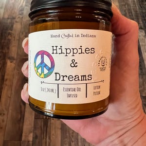 Hippies and Dreams lotion by Teresa Lynns Simple Luxuries.  Presented in 2 sizes of amber glass jars with a white linen label and a tie dyed peace sign on the label.