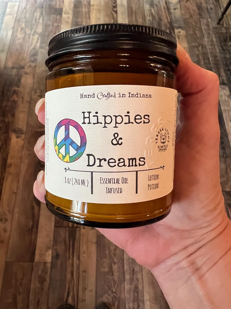 Hippies and Dreams lotion by Teresa Lynns Simple Luxuries.  Presented in 2 sizes of amber glass jars with a white linen label and a tie dyed peace sign on the label.