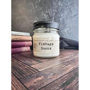 May include: A white ceramic mug with a black handle and the text "But First, Coffee" in a handwritten style. The mug is on a white surface. The mug is approximately 4 inches tall.