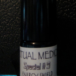May include: A small, black roll-on bottle with a white label that reads "Ritual Medic Special #3 Energy Shield".