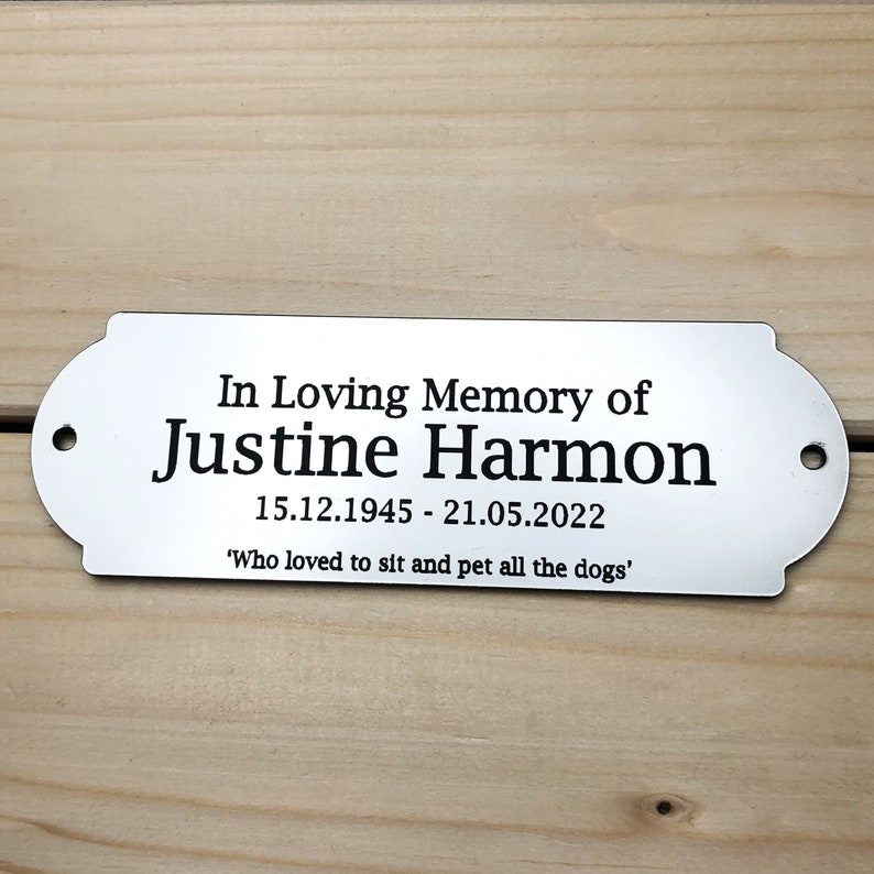May include: Silver memorial plaque with the text "In Loving Memory of Justine Harmon 15.12.1945 - 21.05.2022 'Who loved to sit and pet all the dogs'"