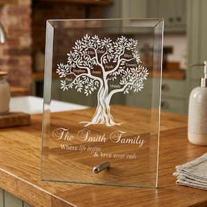 May include: A clear glass family tree plaque with a silver metal stand. The tree design features names like Ellis, Dale, and Rhys. The text reads "The Smith Family" and "Where life begins & love never ends."