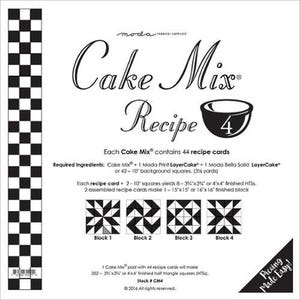May include: A white square with the text "Cake Mix Recipe" and a bowl illustration. The square includes instructions for making quilt blocks, with four block designs shown. A black and white checkered pattern is on the left side.
