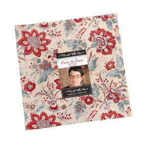 May include: A square fabric piece with a floral pattern in red, blue, and beige. The fabric features large stylized flowers and foliage. A tag with the text "Fleur de Paris" and a woman's image is attached.