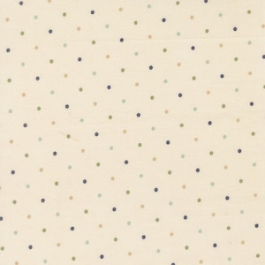 May include: A cream-colored fabric featuring a repeating pattern of small, evenly spaced polka dots in alternating shades of navy blue, sage green, and light tan. The textile has a visible woven texture with a consistent, simple geometric design.