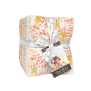 May include: A stack of floral fabric squares tied with a white ribbon printed with measurements and the words "moda fabrics + supplies". The fabric features a pattern of small orange and white flowers with green leaves on a beige background.