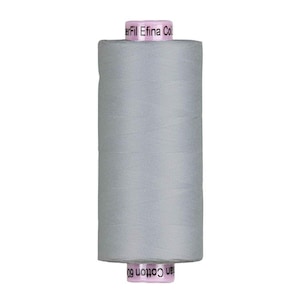 May include: A spool of light gray thread, labeled "Efina Cotton 60." The thread is tightly wound on a cylindrical core, with the brand name printed on the top and bottom of the spool. Ideal for sewing and crafting projects.