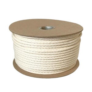May include: A spool of off-white, twisted cotton cord wrapped around a circular, tan-colored cardboard reel. The cord is wound tightly in multiple layers, creating a cylindrical shape with a metallic center hole visible at the top of the spool.