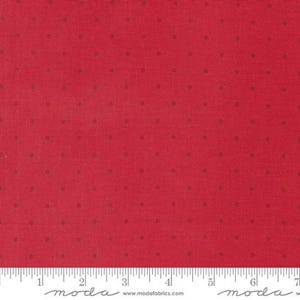 May include: Red fabric with small, evenly spaced brown dots. The fabric has a textured appearance and a ruler is shown at the bottom. The fabric is suitable for quilting, sewing, and other craft projects.