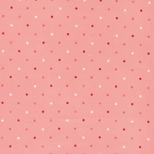 May include: A pink fabric with a repeating pattern of white, red, and light pink polka dots.
