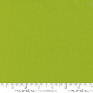 May include: A solid green fabric swatch with a subtle texture. The fabric is a light green color and has a slightly rough feel. The swatch is measured in inches.