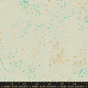 May include: Cream-colored fabric with a speckled pattern of teal, orange, and gold dots. The fabric has a subtle texture and a light, airy feel. The text "RUBY STAR SOCIETY" is at the bottom.