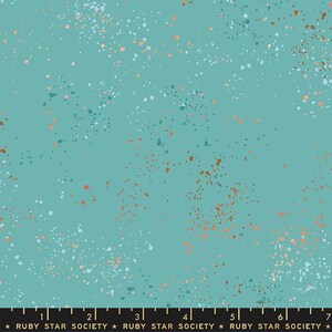 May include: Teal fabric with a speckled pattern. The fabric features small, irregular dots in white, copper, and teal, scattered across the surface. The text "RUBY STAR SOCIETY" is printed along the bottom edge of the fabric.