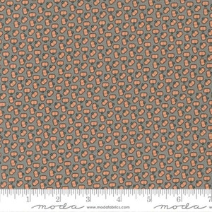 May include: A gray fabric with a repeating pattern of small orange pumpkins. The fabric has a ruler with the words "moda" and "www.modafabrics.com" printed on it.