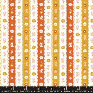 May include: A white fabric with a repeating pattern of vertical stripes in orange, yellow, and pink. The stripes are decorated with small floral and butterfly motifs.