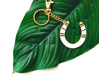 lucky serape horseshoe keychain in black and white on gold