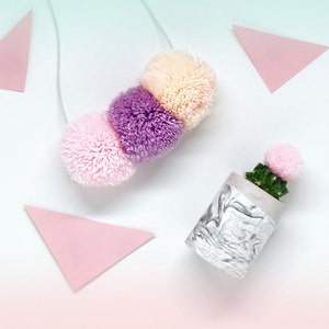 3 pom pom necklace on pastel ombre cord pastel pink, pastel purple and pastel coral combo