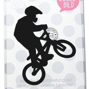 Könnte beinhalten: Schwarz-weißes Bügelbild einer Silhouette einer Person auf einem Fahrrad. Das Bild enthält den Text "BÜGEL-BILD" und "MIMMIS TRAKTOR®".