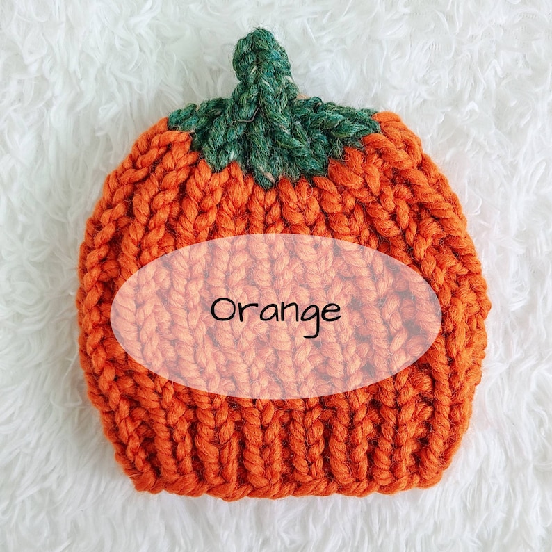 May include: Orange knitted pumpkin hat with a green stem.
