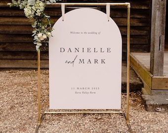 May include: A pink wedding sign with a gold frame. The sign reads "Welcome to the wedding of Danielle and Mark, 11 March 2023, Yarra Valley Farm".
