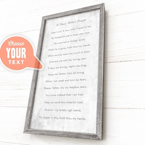 May include: A framed print with the text "A Navy Wife's Prayer" in a gray wooden frame. The print has a white background with black text. A speech bubble graphic with the words "Choose Your Text" is in the corner.