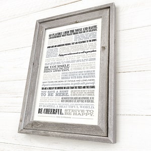 May include: A framed print with a white background and black text. The text is a poem titled "Desiderata" by Max Ehrmann. The poem is about living a peaceful and fulfilling life. The frame is a rustic gray wood.