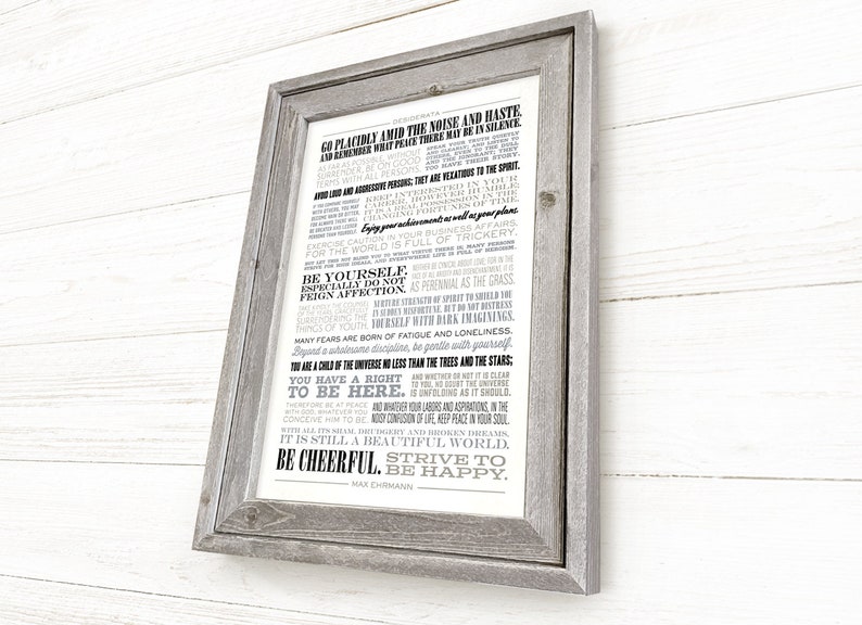 May include: A framed print with a white background and black text. The text is a poem titled "Desiderata" by Max Ehrmann. The poem is about living a peaceful and fulfilling life. The frame is a rustic gray wood.