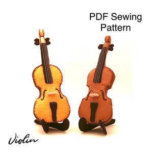 May include: PDF sewing pattern for a felt violin. The pattern includes two different colour options: a yellow violin and a brown violin. Both violins are on a black stand. The text "Violin" is written in cursive at the bottom of the image. The text "PDF Sewing Pattern" is written in black at the top of the image.