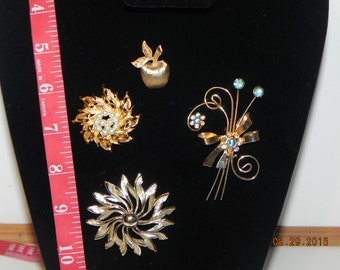 4 Vintage Pins; Apple, 2 flowerish looking ones and 1 with stones on it.They all are goldish in color