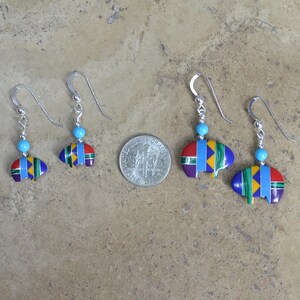 May include: Three pairs of sterling silver earrings with turquoise beads and a colorful bear paw design. The earrings are different sizes, with the largest pair being about the size of a US quarter.