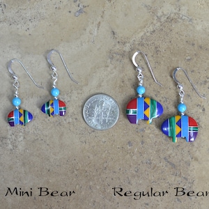 May include: Two pairs of sterling silver earrings with turquoise beads and bear-shaped pendants. The pendants are decorated with colorful geometric patterns. The earrings are labeled "Mini Bear" and "Regular Bear".