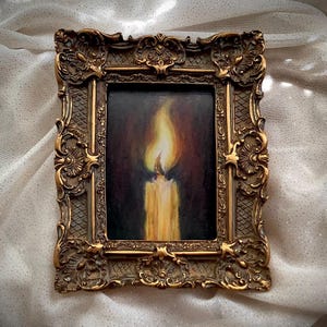 ornate framed art, candle painting