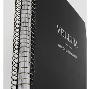 May include: A black Legacy Planner with spiral binding. The cover features the word "VELLUM" and the text "END-OF-LIFE ORGANIZER." The top of the image reads "DIGITAL END OF LIFE ORGANIZER LEGACY PLANNER." The bottom of the image reads "DOWNLOADABLE PDFS."