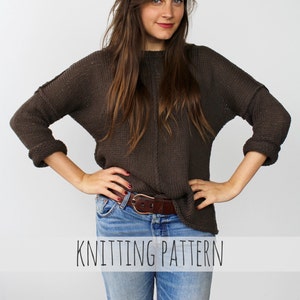 May include: A woman wearing a brown knitted jumper with a brown leather belt and blue jeans. The text "Knitting Pattern" is printed below the image.