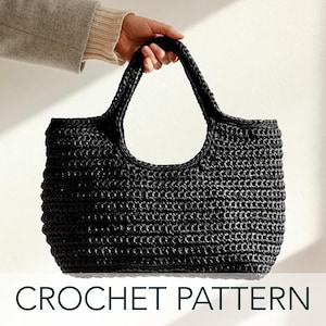 May include: A black crocheted tote bag with a wide, open top and two handles. CROCHET PATTERN is written in green text at the bottom of the image.