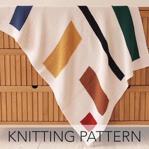 May include: Cream-colored knitted blanket with geometric color blocks in blue, gold, brown, black, green, and red. The words "KNITTING PATTERN" are printed at the bottom of the image.