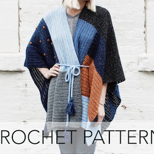 May include: A crochet poncho with a geometric pattern in shades of blue, gray, and orange. The poncho has a tie closure and tassels.