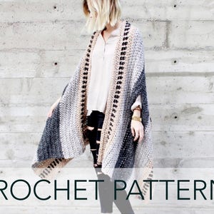 May include: A crochet pattern for a gray, black, and beige striped shawl with a black and beige border. The shawl is draped over a person's shoulders.