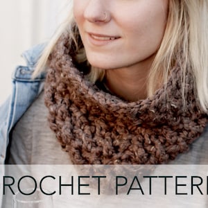May include: A brown crocheted cowl neck scarf worn by a person with blonde hair. The scarf is made with a chunky yarn and has a textured stitch pattern. CROCHET PATTERN is written in white text on a dark green background.