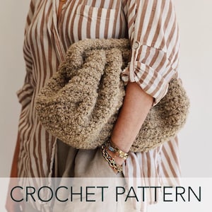 May include: A crochet pattern for a fluffy, brown, oversized clutch bag. The bag is being held by a person wearing a striped shirt.