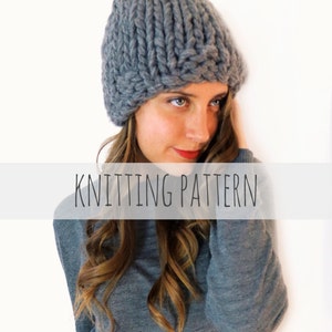 May include: A gray knitted beanie hat with a slouchy fit. The hat is made with thick yarn and has a simple stitch pattern.  KNITTING PATTERN.