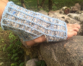 May include: A blue and beige knitted foot warmer with a ribbed design. The open-toe design allows for comfort and breathability. The foot warmer is made of a soft, textured yarn.