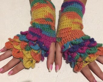 May include: A pair of colorful, handmade fingerless gloves. The gloves are crocheted with a rainbow of colors, including yellow, orange, pink, blue, and green. The cuffs and edges have a scalloped design.